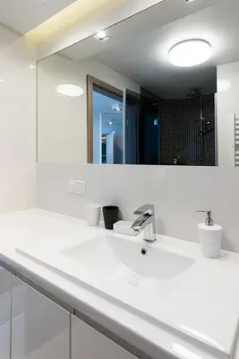a white bathroom with a sink and a mirror at Cozy and Large 62 m2 Apartment with Air Conditioning, Old Town in Kraków