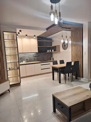 a kitchen and dining room with a table and chairs at Apartament N89 Wiślane Tarasy in Kraków