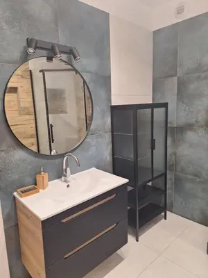 a bathroom with a sink and a mirror at Apartament N89 Wiślane Tarasy in Kraków