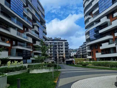 an empty street in a city with tall buildings at Apartament N89 Wiślane Tarasy in Kraków