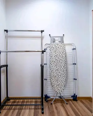 a metal towel rack next to a white wall at Apartament N89 Wiślane Tarasy in Kraków