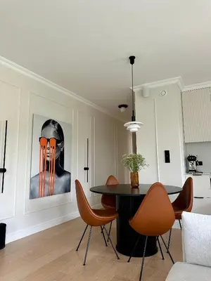 a dining room with a table and orange chairs at Pearl of the city in Kraków