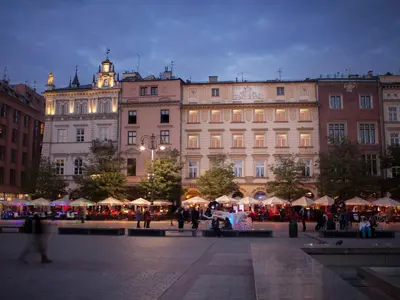 a group of people walking in front of a building at Hotel Betmanowska Main Square Residence Adults Only in Kraków
