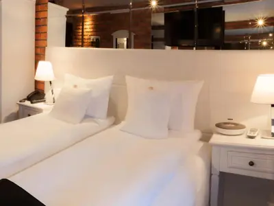 a bedroom with two beds with white pillows at Hotel Betmanowska Main Square Residence Adults Only in Kraków