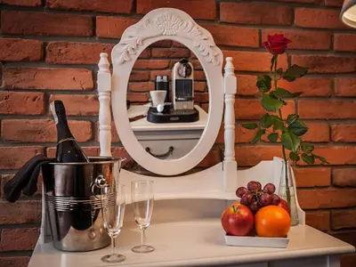 a mirror on a table with fruit and wine glasses at Hotel Betmanowska Main Square Residence Adults Only in Kraków
