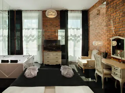 a bathroom with a tub and a sink and a desk at Hotel Betmanowska Main Square Residence Adults Only in Kraków