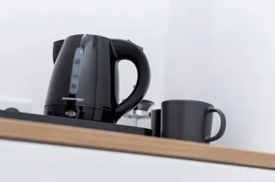 a tea kettle and two cups on a shelf at Cracow Miodowa 42 Elegant Studios by Noclegi Renters in Kraków