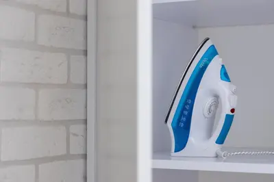 a blue and white hair dryer sitting on a shelf at Cracow Miodowa 42 Elegant Studios by Noclegi Renters in Kraków