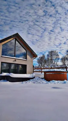 a house with snow in front of it at Brzozowe Zacisze in Lachowice