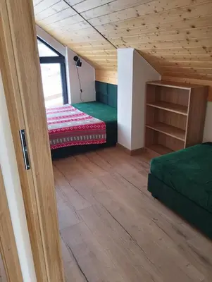 a room with two beds and a window at Brzozowe Zacisze in Lachowice