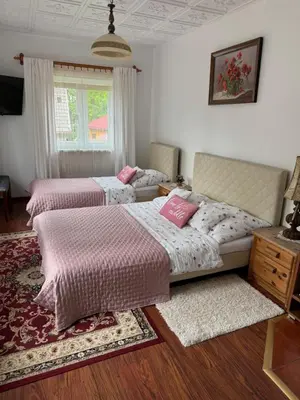 a bedroom with two beds and a window at Gościniec Grek Zorba - pokoje i domki 4 osobowe - 16km od Zator Energylandia in Inwałd