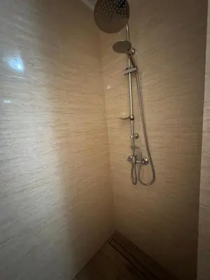 a shower with a shower head in a bathroom at Gościniec Grek Zorba - pokoje i domki 4 osobowe - 16km od Zator Energylandia in Inwałd