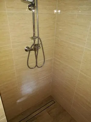 a shower with a shower head in a bathroom at Gościniec Grek Zorba - pokoje i domki 4 osobowe - 16km od Zator Energylandia in Inwałd