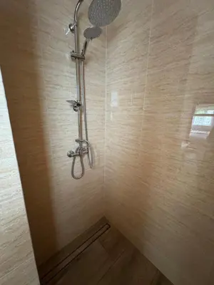 a shower with a shower head in a bathroom at Gościniec Grek Zorba - pokoje i domki 4 osobowe - 16km od Zator Energylandia in Inwałd