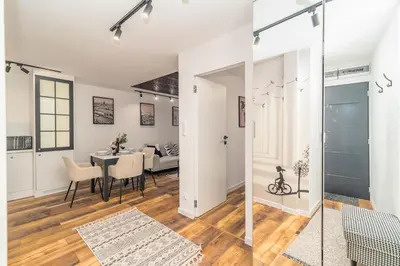 a living room and dining room with a table and chairs at Prądnik Biały Apt - Parks Nearby - by Rentujemy in Kraków