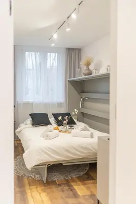 a bedroom with a large bed with white sheets at Prądnik Biały Apt - Parks Nearby - by Rentujemy in Kraków