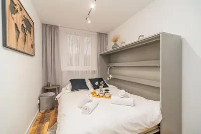 a bedroom with a bed with two towels on it at Prądnik Biały Apt - Parks Nearby - by Rentujemy in Kraków