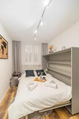 a bedroom with a large bed with two towels on it at Prądnik Biały Apt - Parks Nearby - by Rentujemy in Kraków
