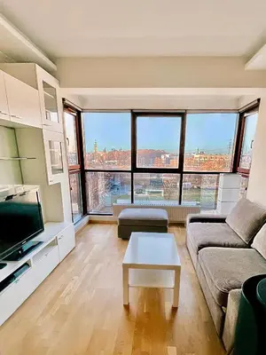 a living room with a couch and a table at No̱410 City View Apartment & free private parking in Kraków
