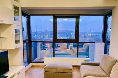 a living room with a large window with a view at No̱410 City View Apartment & free private parking in Kraków