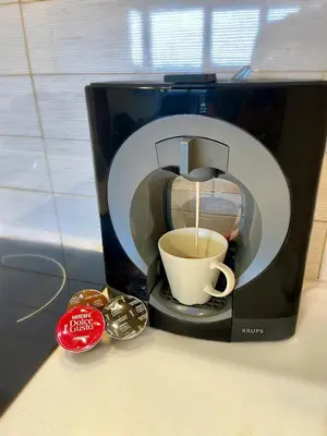 a coffee maker is making a cup of coffee at No̱410 City View Apartment & free private parking in Kraków