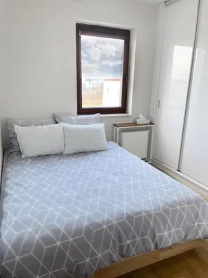 a bedroom with a large bed with a window at No̱410 City View Apartment & free private parking in Kraków