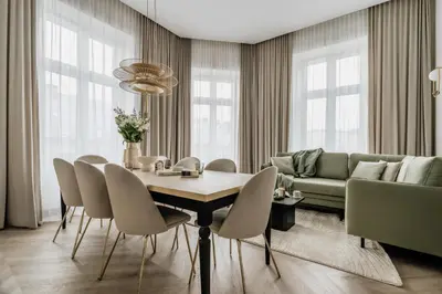 a living room with a table and chairs and a couch at Millou by StayLab in Kraków