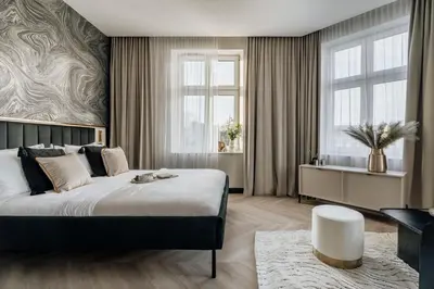 a bedroom with a large bed and a window at Millou by StayLab in Kraków