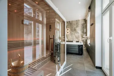 a bathroom with a tub and a sink at Millou by StayLab in Kraków