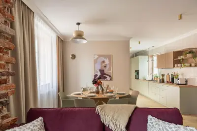 a living room with a purple couch and a table at Red Roof Apartments Old Town in Kraków