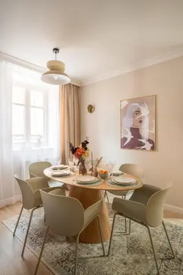 a wooden table with a plate with an apple on it at Red Roof Apartments Old Town in Kraków