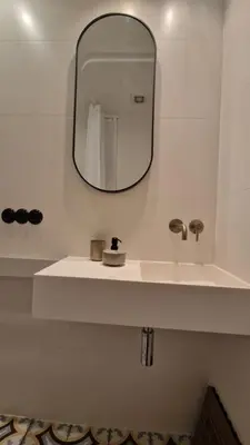 a bathroom with a white sink and a mirror at Noce i Dnie in Kraków