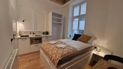 a bedroom with a bed with towels on it at Noce i Dnie in Kraków