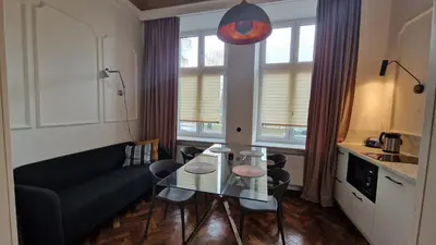 a living room with a couch and a glass table at Noce i Dnie in Kraków