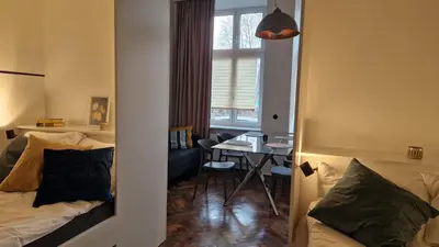 a room with a bed and a desk with a window at Noce i Dnie in Kraków