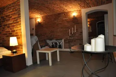 a living room with a brick wall and a table at Topola in Kraków
