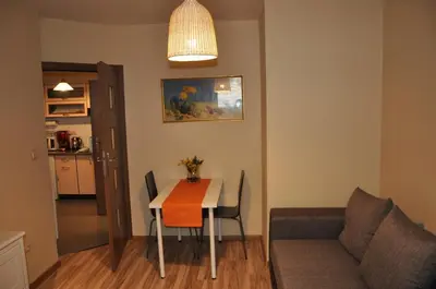 a living room with a table and a couch at Topola in Kraków