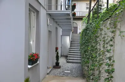 an alley with stairs and plants on a building at Topola in Kraków