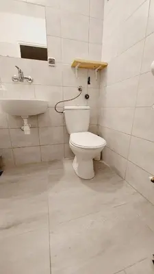 a bathroom with a toilet and a sink at Korona Rooms in Kraków