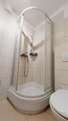a shower in a bathroom with a toilet at Korona Rooms in Kraków