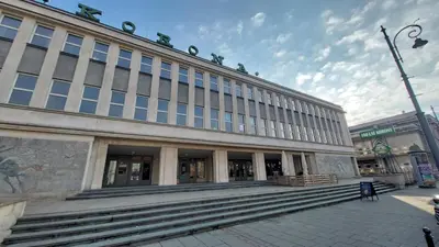 a large building with steps in front of it at Korona Rooms in Kraków