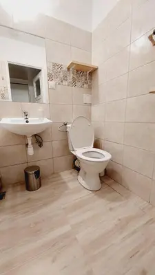 a bathroom with a toilet and a sink at Korona Rooms in Kraków