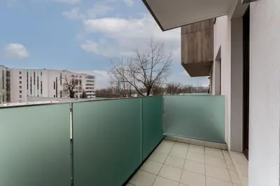 a green fence on a balcony of a building at Cystersów Charming Apartment by BookingHost in Kraków