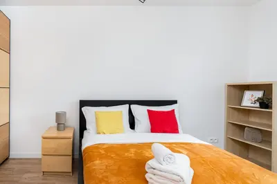 a bedroom with a bed with towels on it at Cystersów Charming Apartment by BookingHost in Kraków