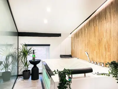 a bath tub in a room with potted plants at Apartment Premium Jacuzzi, Old Town Cracow in Kraków