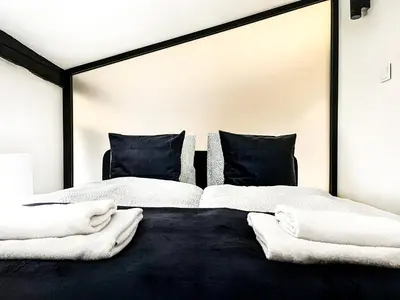 two beds in a bedroom with white sheets and pillows at Apartment Premium Jacuzzi, Old Town Cracow in Kraków