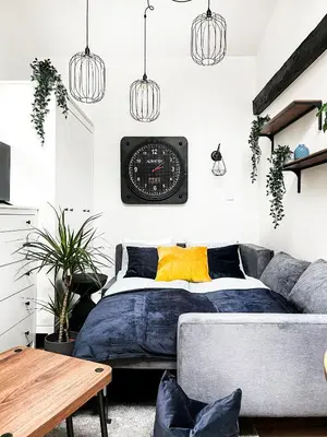 a bedroom with a bed and a clock on the wall at Apartment Premium Jacuzzi, Old Town Cracow in Kraków