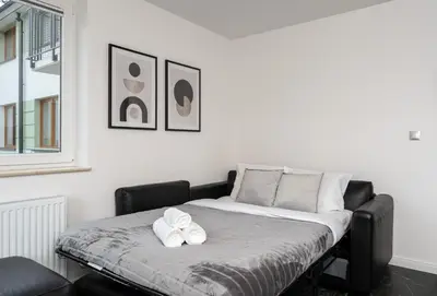 a bed with two towels on it in a room at Apartments Deluxe Cannes 51 by BookingHost in Kraków