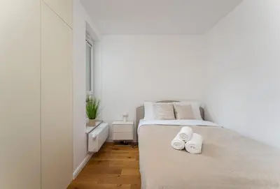 a bedroom with a bed with white towels on it at Apartments Deluxe Cannes 51 by BookingHost in Kraków