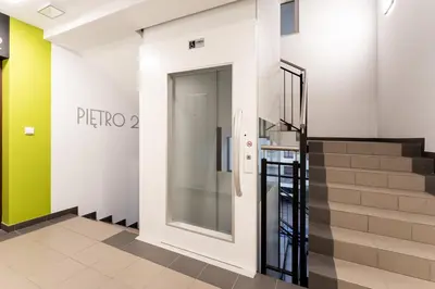 a glass door in a building with a staircase at Apartments Deluxe Cannes 51 by BookingHost in Kraków